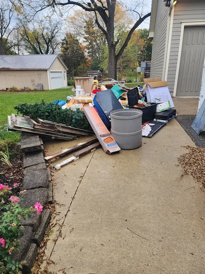 Dumpster being loaded with debris for Estate Cleanout Dumpster Rental in Charlotte Harbor